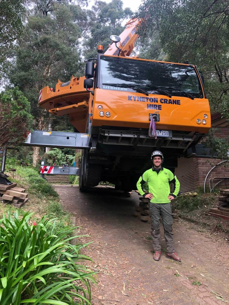 tree arborist standing in front of crane, crane to be used for tree removal in Melbourne